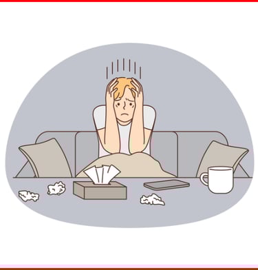 a sad man sitting on a couch with a laptop and papers