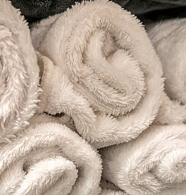 rolled white towels stacked 