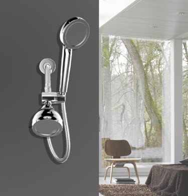 Modern chrome dual shower head system with handheld sprayer mounted on a dark grey bathroom wall.