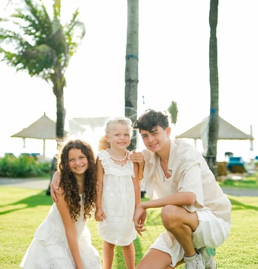 Family portrait framed by the iconic swing structure at Ayodya Resort Bali in Nusa Dua