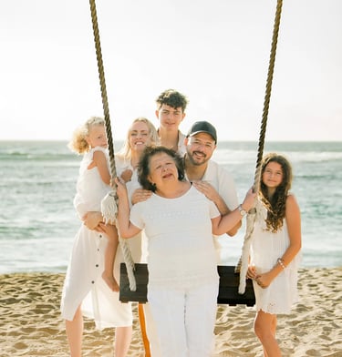 Family portrait beside the iconic beach swing at Ayodya Resort Bali in Nusa Dua