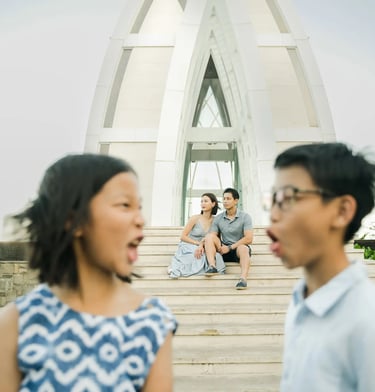 Family standing in front of the iconic chapel during a luxury family photography session at The Ritz-Carlton Bali.
