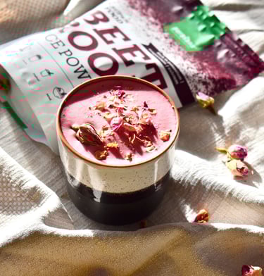 a cup of pink latte with a bag of beetroot powder