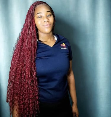a woman with long red boho braids hairstyle
