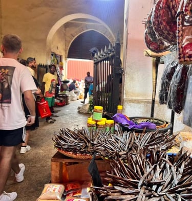 Explore the vibrant displays of spices, herbs, and fresh produce at Darajani Market in historic Stone Town, Zanzibar