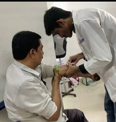 Lab assistant collecting blood sample from patient at Asian Diabetes Center Madinaguda Hyderabad