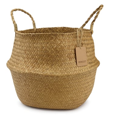 A seagrass woven storage basket with loop handles, styled upright to show its shape and texture 