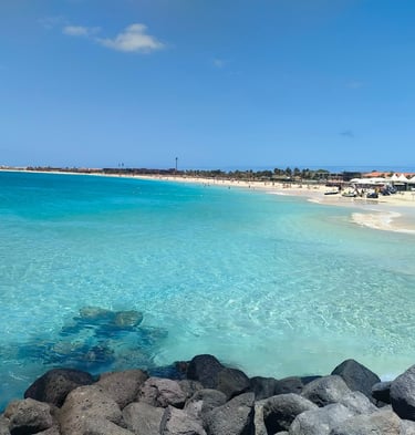 a beach with a blue sky and a clear blue sky
