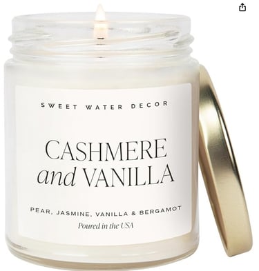 Sweet Water Decor Cashmere and Vanilla scented glass jar candle with a gold lid.