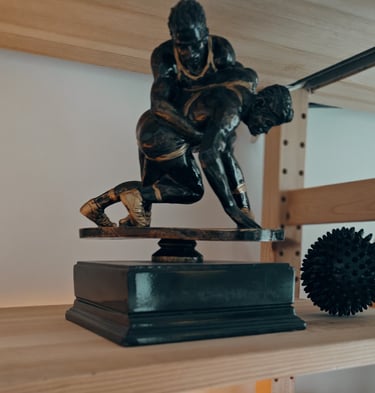 a statue of a man wrestling on a shelf