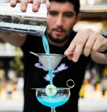 a bar mixer is pouring a cocktail. Staff Training in Hospitality with Timea Pokol Consultant