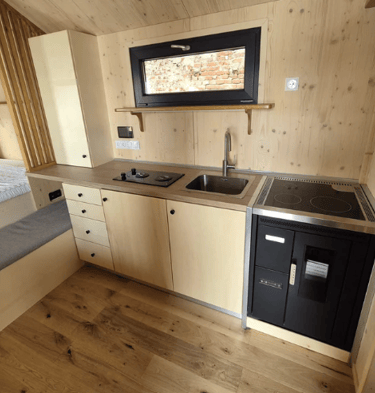 Tiny house kitchen with wooden wall