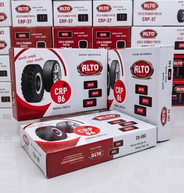 Stacked boxes of Alto CRP-86 radial patches and CRP-37 cold rubber patches for tire repair.
