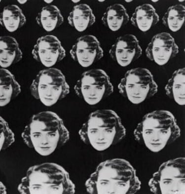 Female dancers holding multiple giant Ruby Keeler face cutouts in a classic Berkeley formation.