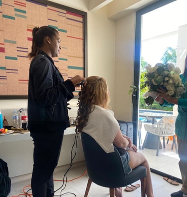 Deya Ventura bridal hair stylist curling a bride’s hair during wedding day preparations in Punta Cana, Dominican Republic