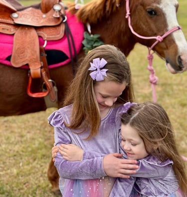 All hugs and joy after riding Snickers at a princess pony party