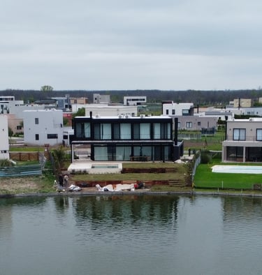a large body of water with houses in the background