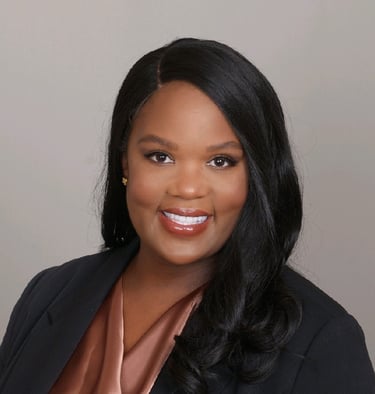 a woman in a black suit and pink blouse