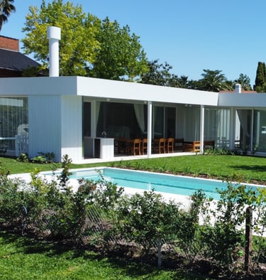 a pool in a backyard with a pool and a fence