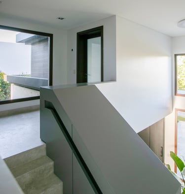 a staircase leading to a large window with a view of the outside