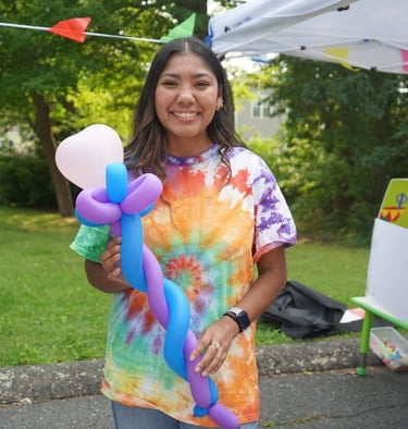 Kid posing with baloon staff