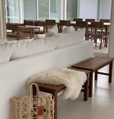 a couch with a basket bag on top of it