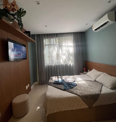 a bedroom with a bed and a television