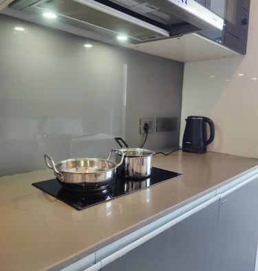 a stove top with all kitchen utensils at Zenith Suites - Noida, Supernova, Supertech