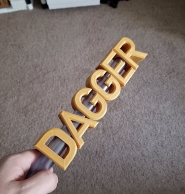 A 3d printed dagger with the blade forming the word dagger