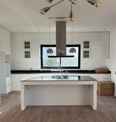 a kitchen with a large island and a large window