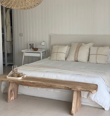 a bed with a wooden bench and a bench with a bench and a table with