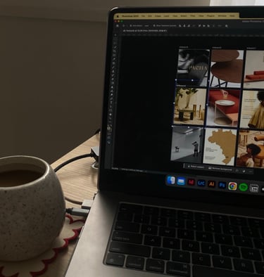 a laptop computer sitting on a table with a cup of coffee