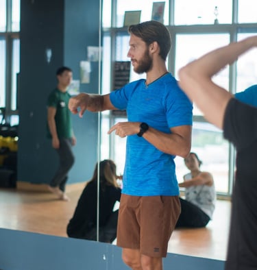 a man in a blue shirt is coaching movement
