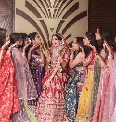an indian bride with group of girls having flying kisses