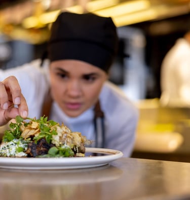 a chef is preparing to serve a meal