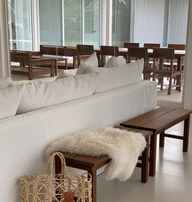 a couch with a basket bag on top of it