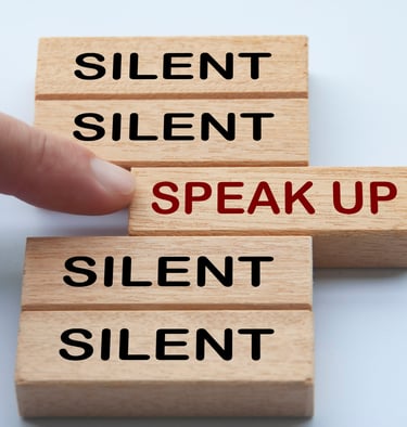 this is a photo pf a women touching what looks like a gamw piece that says "speak up" on it. 