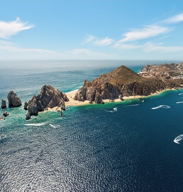 a group of boats sailing in the ocean