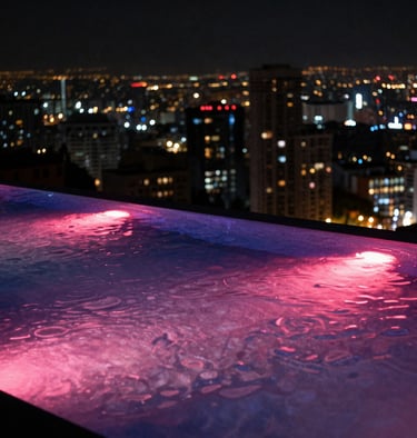 Premium nighttime scene of an infinity pool over looking a metropolitan area, with deep pink and purple neon reflections shimmering on the water surface.
