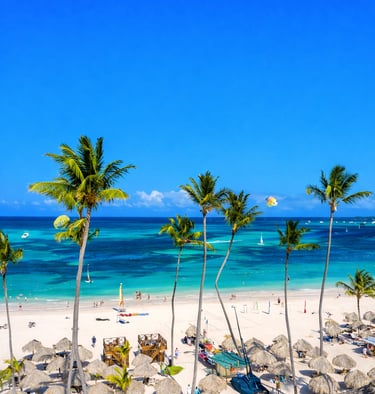 Palm trees and white sand beach at a Dominican Republic all inclusive resort with turquoise ocean and beach loungers