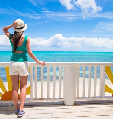 Woman enjoying ocean view on a sunny deck in the Dominican Republic