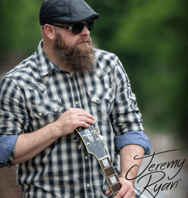 a bearded bearded bearded man with a guitar