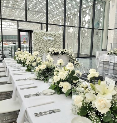 Wedding backdrop with white rose centerpieces 