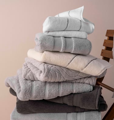 a stack of towels and towels on a chair