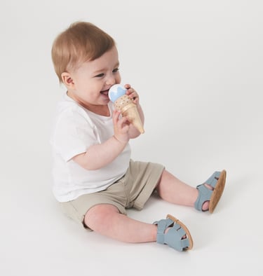 Fashion campaign photography - a baby boy sitting on the floor with a ice cream