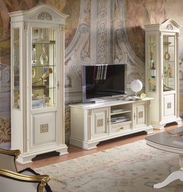 Classic white wooden TV stand and glass display cabinets with gold accents in a luxury living room.