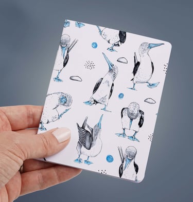 a person holding a notepad with a bird on it