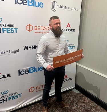 the owner of cafine skincare holding a BetaDen sign