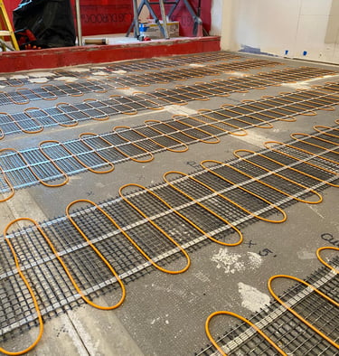 Electric heated bathroom floor installation in Winnetka, IL with new tile and modern fixtures