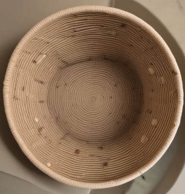 Close-up of a hand tying knots on a jute rope basket